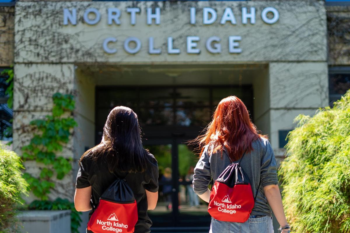 2 Female students walking into building