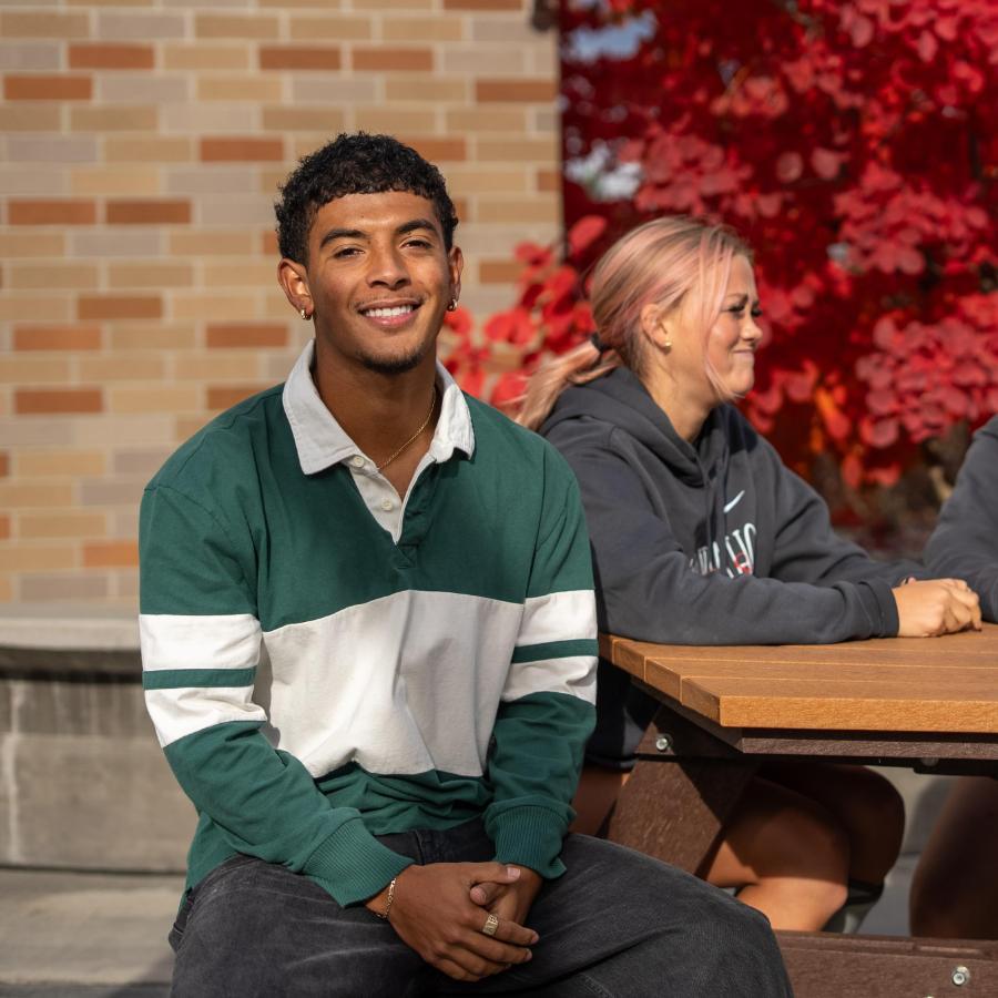 students outside talking at a table