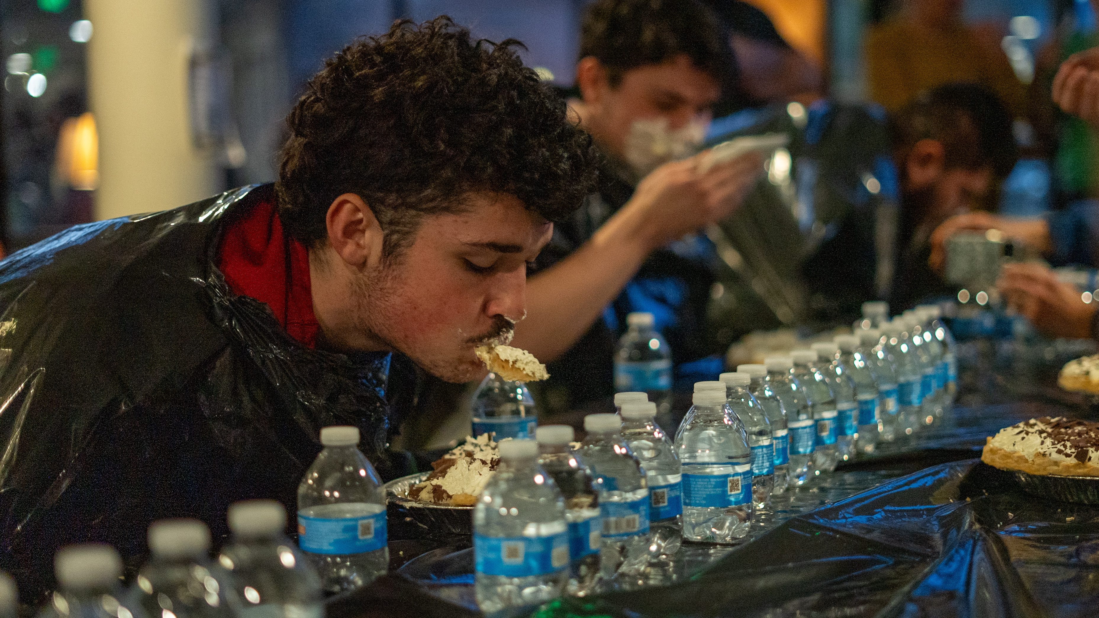 Student eating a Pie at a pie eating contest at the dorms