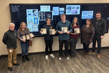 From left: Philippe Valle, NIC Associate Professor; Aurora Bacowsky; Gracie Duncan; Michael Cronin; Sarah Hoare; Lydia Ramus, NIC Adjunct Professor; and Jesse Longacre, NIC Assistant Professor. Students are standing in front of their award-winning designs. Students