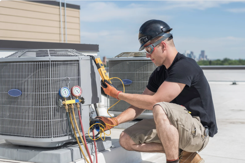 Student using an ohmmeter to test an a/c unit